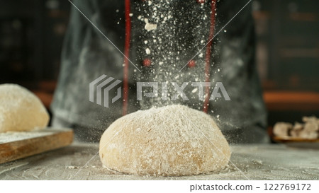 Freeze motion of falling flour on yeast dough. 122769172