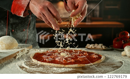 Freeze motion of pizza maker preparing fresh pizza. 122769179