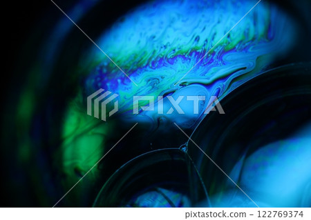Bright rainbow reflection of liquid on black background, blue surface, surrealistic background, fantastic surface movement, beautiful science Bright rainbow reflection of liquid on black background, blue surface, surrealistic background, fantastic surface movement, beautiful science 122769374