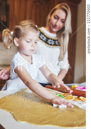 Happy daughter and mom in the kitchen bake cookies Happy daughter and mom in the kitchen bake cookies 122770005