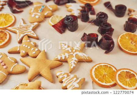 Decorating a spicy cookie with white glaze and orange. Happy New Year. Decorating a spicy cookie with white glaze and orange. Happy New Year. 122770074