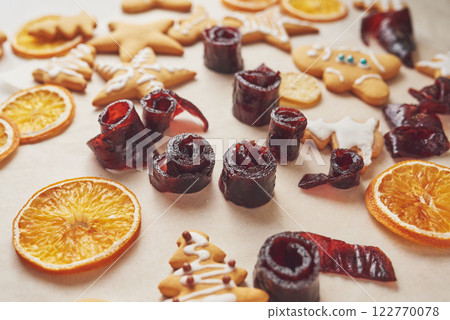 Decorating a spicy cookie with white glaze and orange. Happy New Year. 122770078