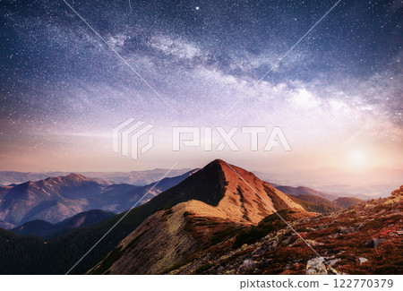 Fantastic landscape in the mountains of Ukraine. Vibrant night sky with stars and nebula and galaxy. Fantastic landscape in the mountains of Ukraine. Vibrant night sky with stars and nebula and galaxy. 122770379