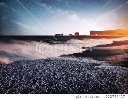 The Rock Troll Toes. Reynisdrangar cliffs. Black sand beach. Iceland. Fantastic starry sky and the milky way The Rock Troll Toes. Reynisdrangar cliffs. Black sand beach. Iceland. Fantastic starry sky and the milky way 122770417