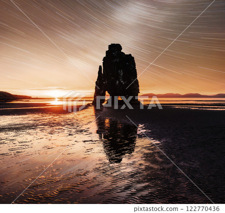starry sky in a spectacular rock in the sea on the Northern coast of Iceland. Legends say it is a petrified troll 122770436