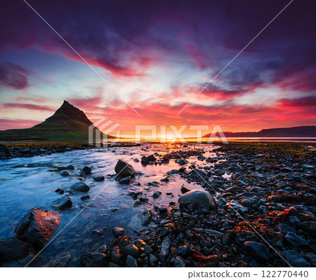 The picturesque sunset over landscapes and waterfalls. Kirkjufell mountain The picturesque sunset over landscapes and waterfalls. Kirkjufell mountain 122770440
