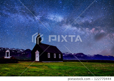 Mountain View Iceland. Fantastic starry sky and the milky way. Beautiful black wooden church in Budir 122770444