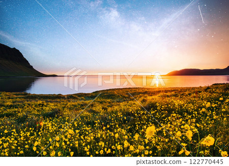 The picturesque sunset over landscapes and waterfalls. Kirkjufell mountain, Iceland The picturesque sunset over landscapes and waterfalls. Kirkjufell mountain, Iceland 122770445