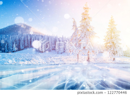 Mysterious winter landscape majestic mountains in winter. Magical winter snow covered tree. Photo greeting card. Bokeh light effect, soft filter. 122770446