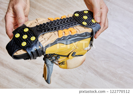 Ice treads securely attached to sole enhance traction and prevent slipping on snowy or icy terrain. Ice treads securely attached to sole enhance traction and prevent slipping on snowy or icy terrain. 122770512