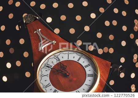 Happy New Year at midnight 2018, Old wooden clock with holiday lights 122770526