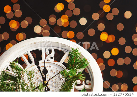 Happy New Year at midnight 2018, Old wooden clock with holiday lights and fir branches 122770534