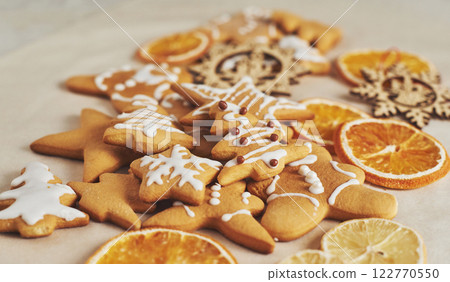 Christmas gingerbread cookies and dried orange and spices on white table Christmas gingerbread cookies and dried orange and spices on white table 122770550