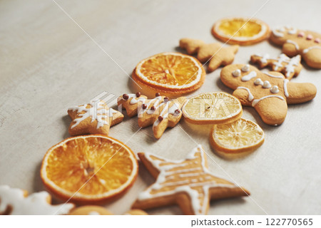 Christmas gingerbread cookies and dried orange and spices on white table Christmas gingerbread cookies and dried orange and spices on white table 122770565