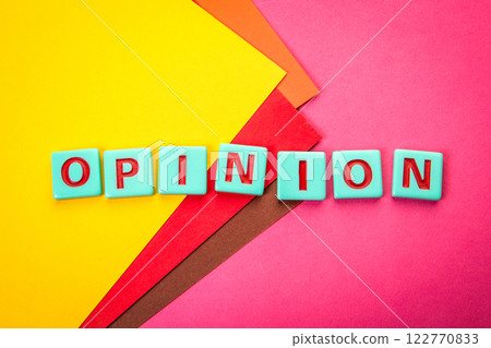 OPINION. Alphabet letter tiles on a red textured background OPINION. Alphabet letter tiles on a red textured background 122770833