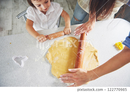 Mom and daughter make homemade cookies. 122770985