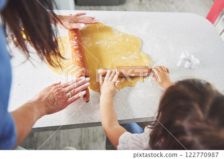 Mom and daughter make homemade cookies. 122770987