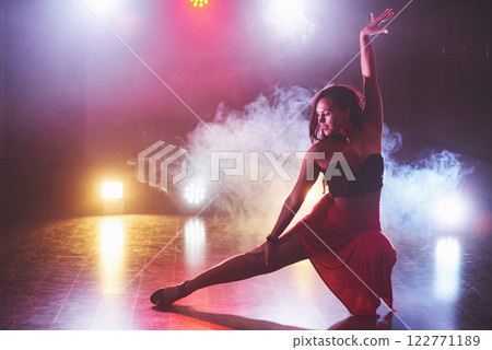 Beautiful girl dancing in the fog in the night club 122771189