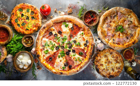 A variety of freshly baked pizzas A variety of freshly baked pizzas 122772130