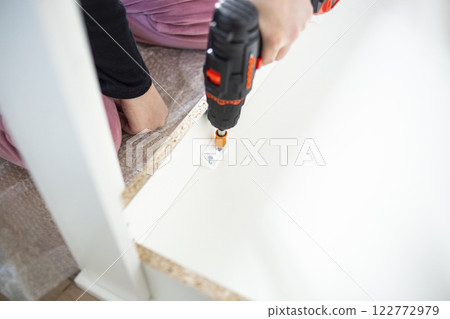 Assembling Furniture with a Drill Assembling Furniture with a Drill 122772979