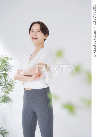 Woman in sportswear with arms crossed Woman in sportswear with arms crossed 122773206