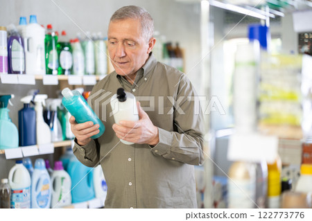 Elderly man choosing a shower gel and shampoo 122773776