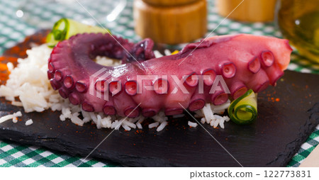 Seafood lunch. Tasty octopus tentacles with rice closeup Seafood lunch. Tasty octopus tentacles with rice closeup 122773831