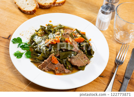 Appetizing beef stew with green beans, carrot and parsley on plate 122773871
