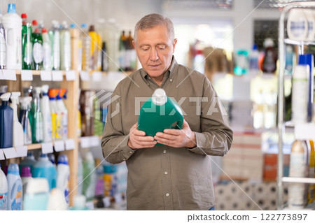 Male consumer with household chemical products for washing indoors Male consumer with household chemical products for washing indoors 122773897
