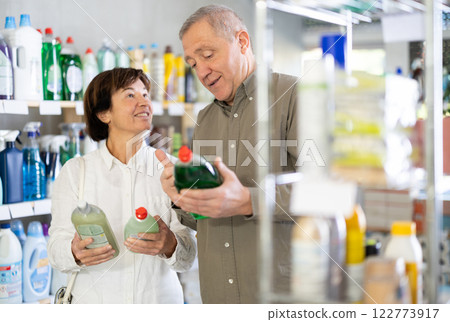 Couple man and woman choosing dishwashing in store 122773917