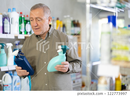 European man choosing spray in supermarket European man choosing spray in supermarket 122773997