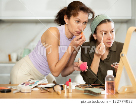 Woman doing eyebrow makeup with brush 122774052