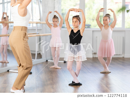 Little girls are learning various dance and ballet movements in studio 122774118