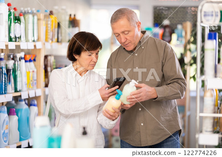 Husband and wife scanning the barcode of liquid soap packaging Husband and wife scanning the barcode of liquid soap packaging 122774226