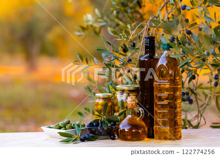 Olive tree and oil products on table outdoors 122774256