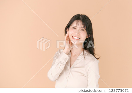 Portrait of a woman in her twenties wearing a shirt Portrait of a woman in her twenties wearing a shirt 122775071