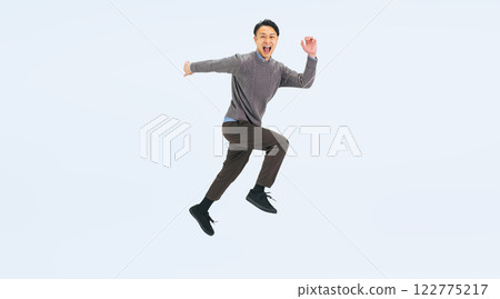 Full body photo of a middle-aged man in casual clothing jumping Full body photo of a middle-aged man in casual clothing jumping 122775217