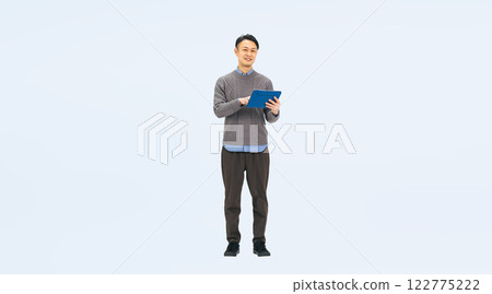 Full-body photo of a middle-aged man in casual wear using a tablet 122775222