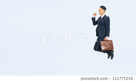 Full body photo of a middle-aged male business person jumping 122775238