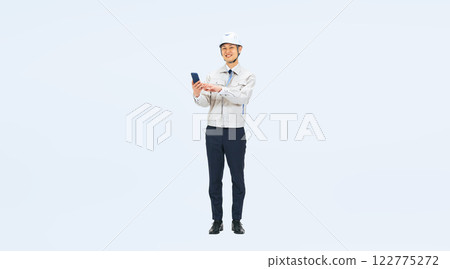 Full-body photo of a middle-aged man wearing work clothes using a smartphone Full-body photo of a middle-aged man wearing work clothes using a smartphone 122775272