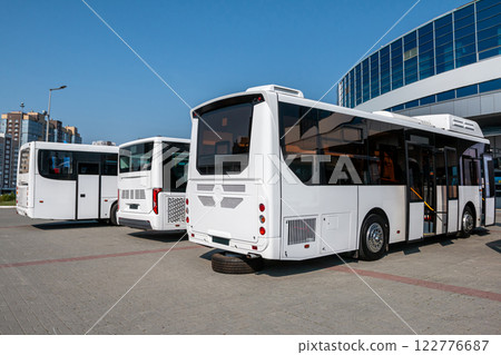White city buses at the bus station on a clear day White city buses at the bus station on a clear day 122776687
