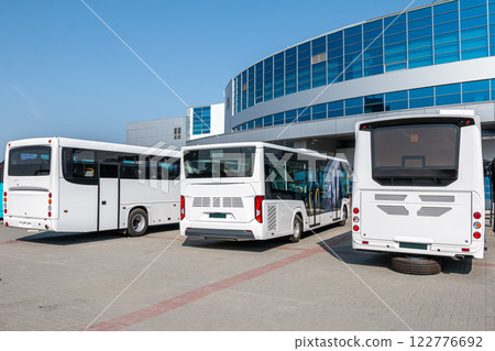 White city buses at the bus station on a clear day White city buses at the bus station on a clear day 122776692
