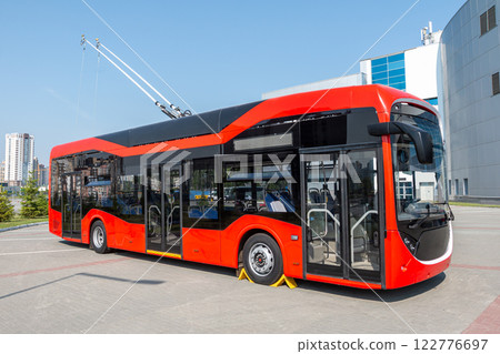 Modern red trackless trolley at the trolleybus station 122776697