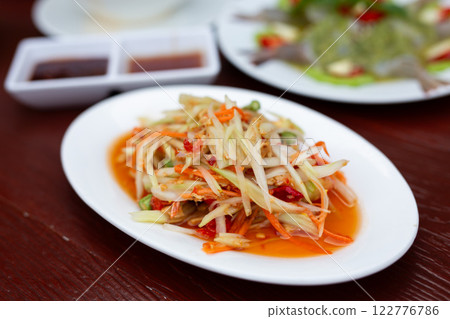 Thai food papaya salad (Som Tum) on a wooden table 122776786