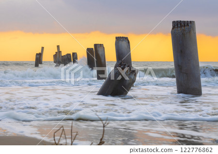 A beautiful sunrise at Sao Eang Beach (Old leaning cement pillars) Cha-Am beach is a famous about a lot of old leaning cement pillars of the pier located in Cha-Am beach Phetchaburi A beautiful sunrise at Sao Eang Beach (Old leaning cement pillars) Cha-Am beach is a famous about a lot of old leaning cement pillars of the pier located in Cha-Am beach Phetchaburi 122776862