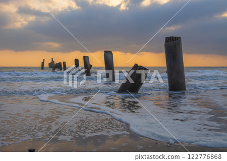 A beautiful sunrise at Sao Eang Beach (Old leaning cement pillars) Cha-Am beach is a famous about a lot of old leaning cement pillars of the pier located in Cha-Am beach Phetchaburi 122776868