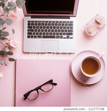 A flat lay of an open laptop on a pastel background, with a cup of coffee, glasses and green leaves beside it. 122777196