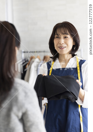 A woman serving customers 122777559