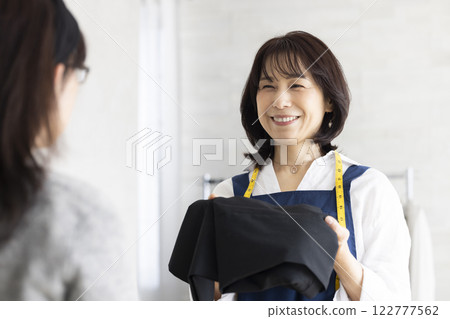 A woman serving customers 122777562