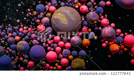 Colorful bubble. Art blob. Pink violet planet balls on black mystic surface. Defocused abstract background acrylic round gel drop. 122777641